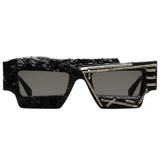 Kuboraum Mask X12 rectangular sunglasses in textured black acetate with metal detailing, the Mask documented on Madonna