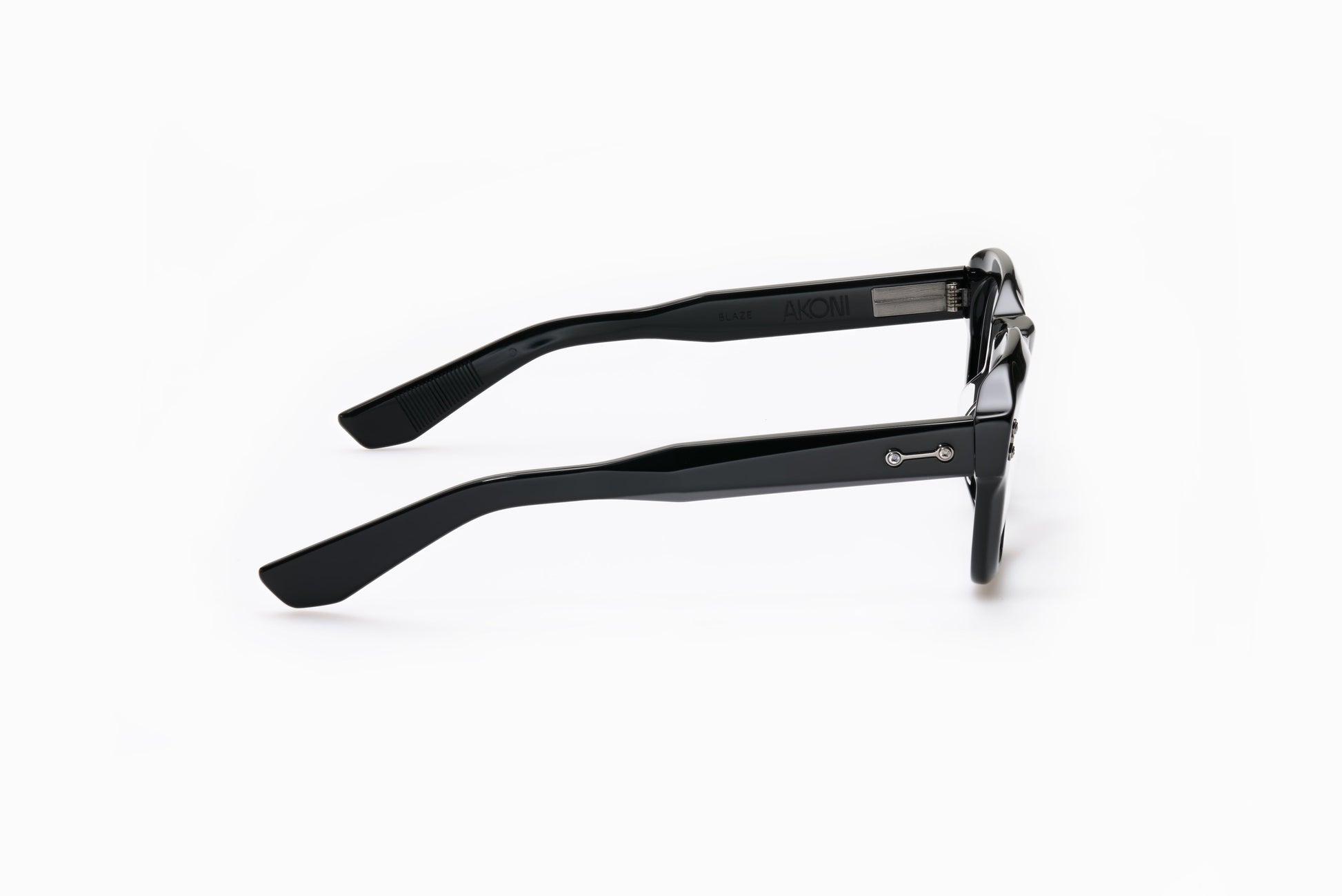 Side view of Akoni Blaze eyeglasses in Black, rectangular frame, polished finish, and metallic temple accents.