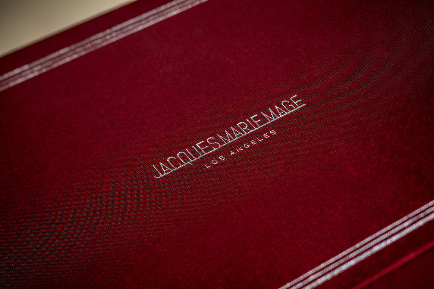 Jacques Marie Mage custom monograph box in the brand's signature burgundy Bordeaux Empire color.