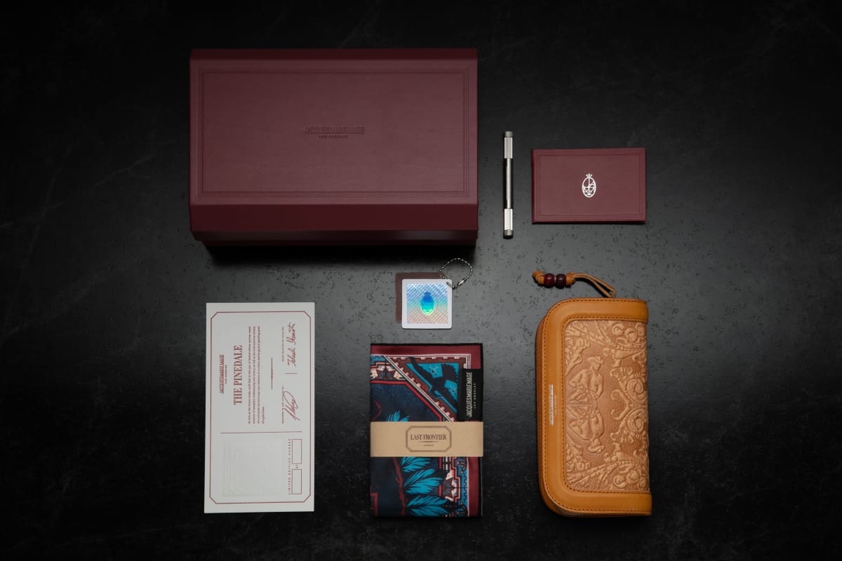 Jacques Marie Mage and The Last Frontier exlusive packaging featuring a custom leather box with magnetic closure, handmade leather wallet case, custom stainless steel screwdriver ft. handgrip and burgundy enamel fill detail, custom cleaning cloth, and custom warranty leather booklet.
