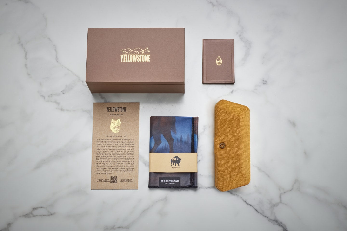The Jacques Marie Mage x Yellowstone  VI collection eyewear comes with an eco-friendly monograph box in brown with gold foil, JMM's signature warranty booklet, Yellowstone hard case, a Yellowstone microfiber cleaning cloth, and a certificate of authenticity with limited edition serial number.