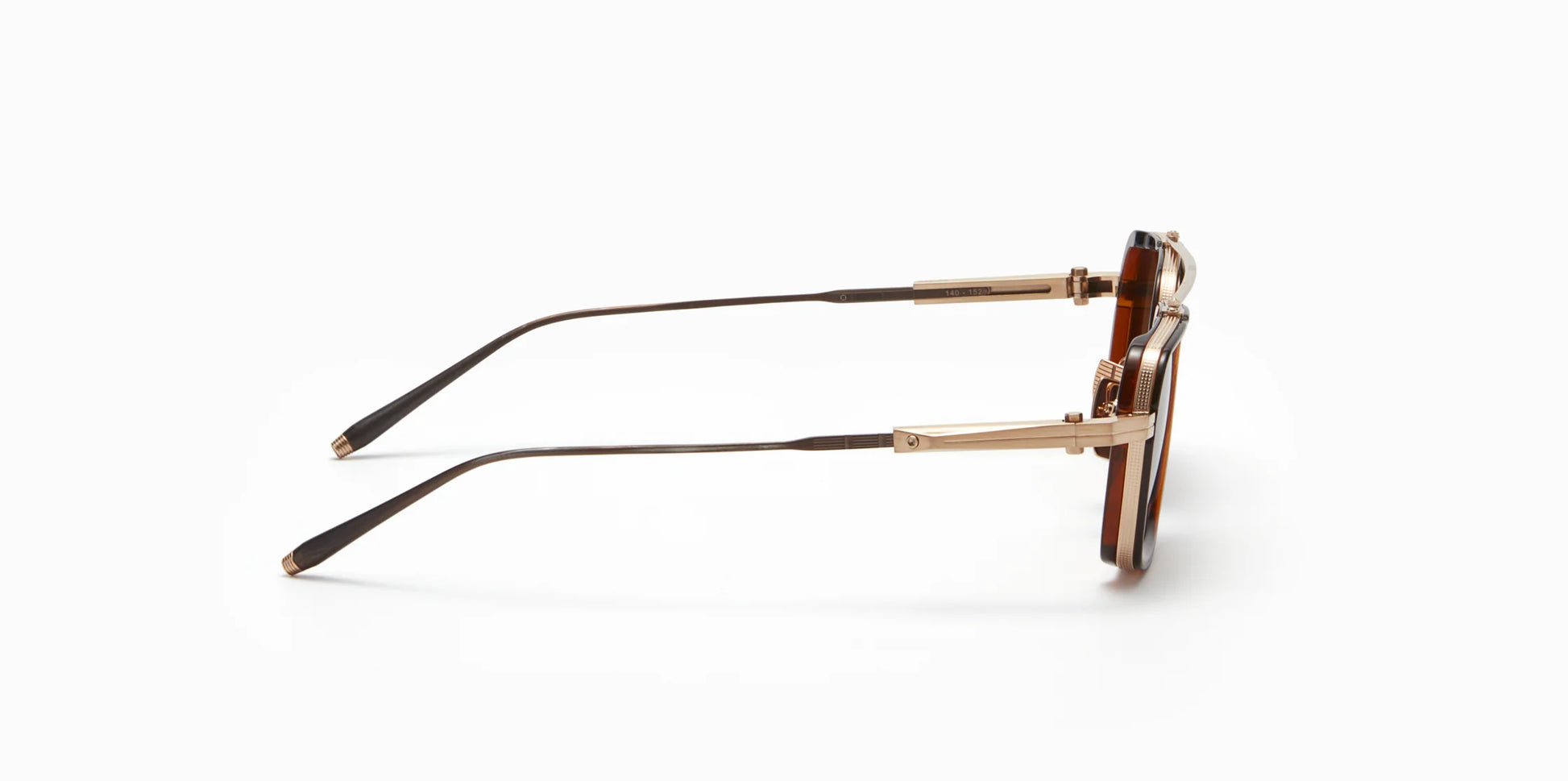 Side view of Akoni's new "Solis" frame in the white gold/dark brown crystal colorway, a squared-off navigator silhouette with adjustable temples and a sculpted Japanese Acetate front set within a striking Japanese Titanium frame.