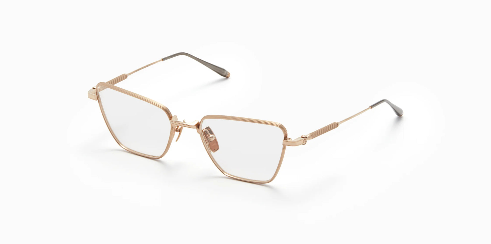 Three-quarter profile view of Akoni's new "Vega" frame in the brushed white gold colorway.