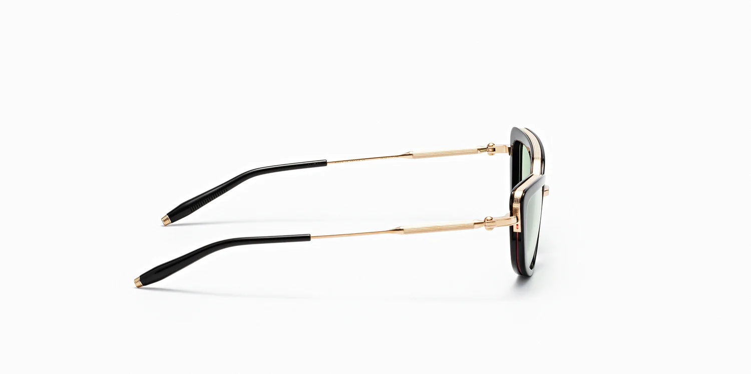 The side of "Venus" frame model by Akoni in the black and gold colorway, featuring a shiny black geometric cat eye frame front with a polished gold trim that extends to the temples, which are capped with Akoni's signature acetate temple tips.