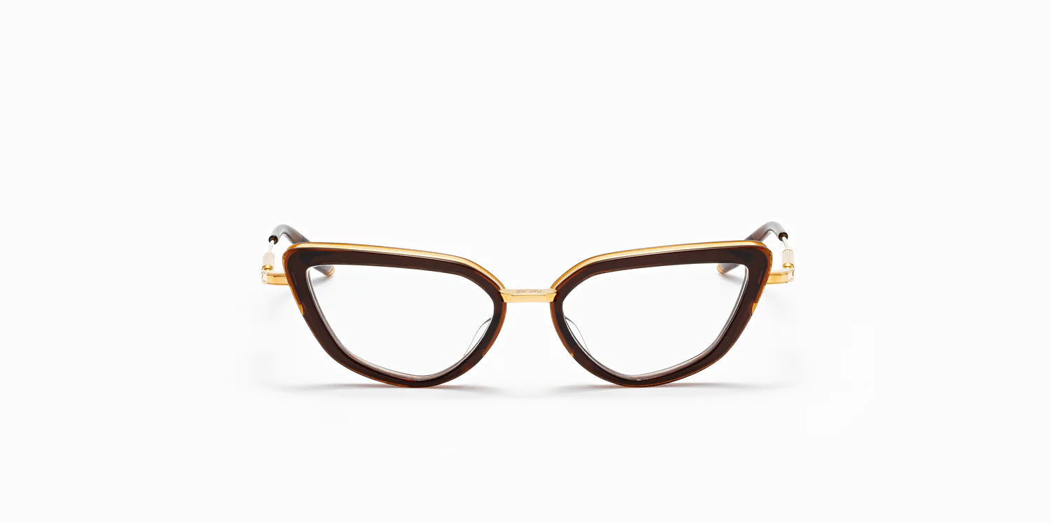 Front of "Venus" frame model by Akoni in the crystal brown and gold colorway, featuring a shiny dark brown geometric cat eye frame front with a polished gold trim that extends to the temples, which are capped with Akoni's signature acetate temple tips.